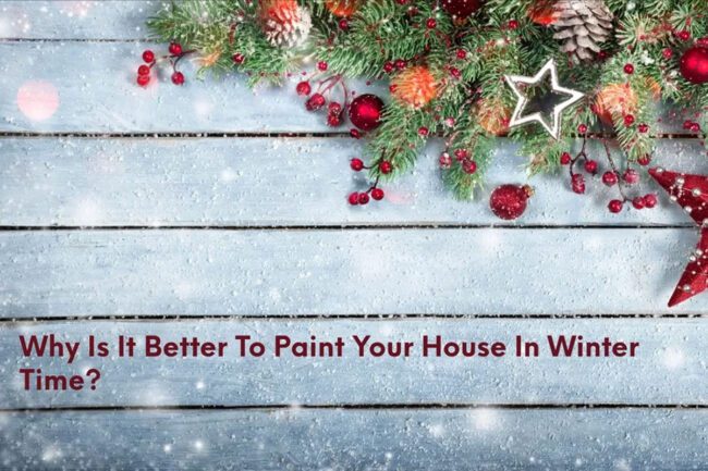 Holiday-themed decoration on a wooden surface with text questioning the benefits of painting a house during winter.